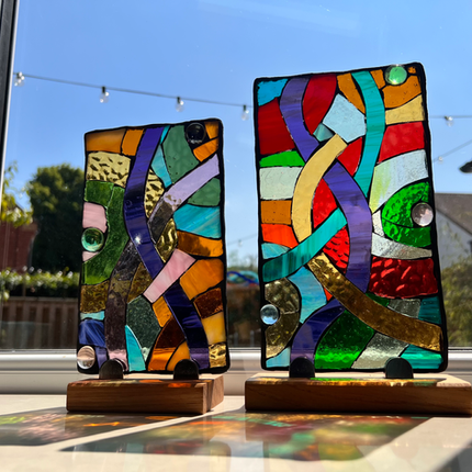 Stained glass mosaic panels with oak display stands to add colour to the home.