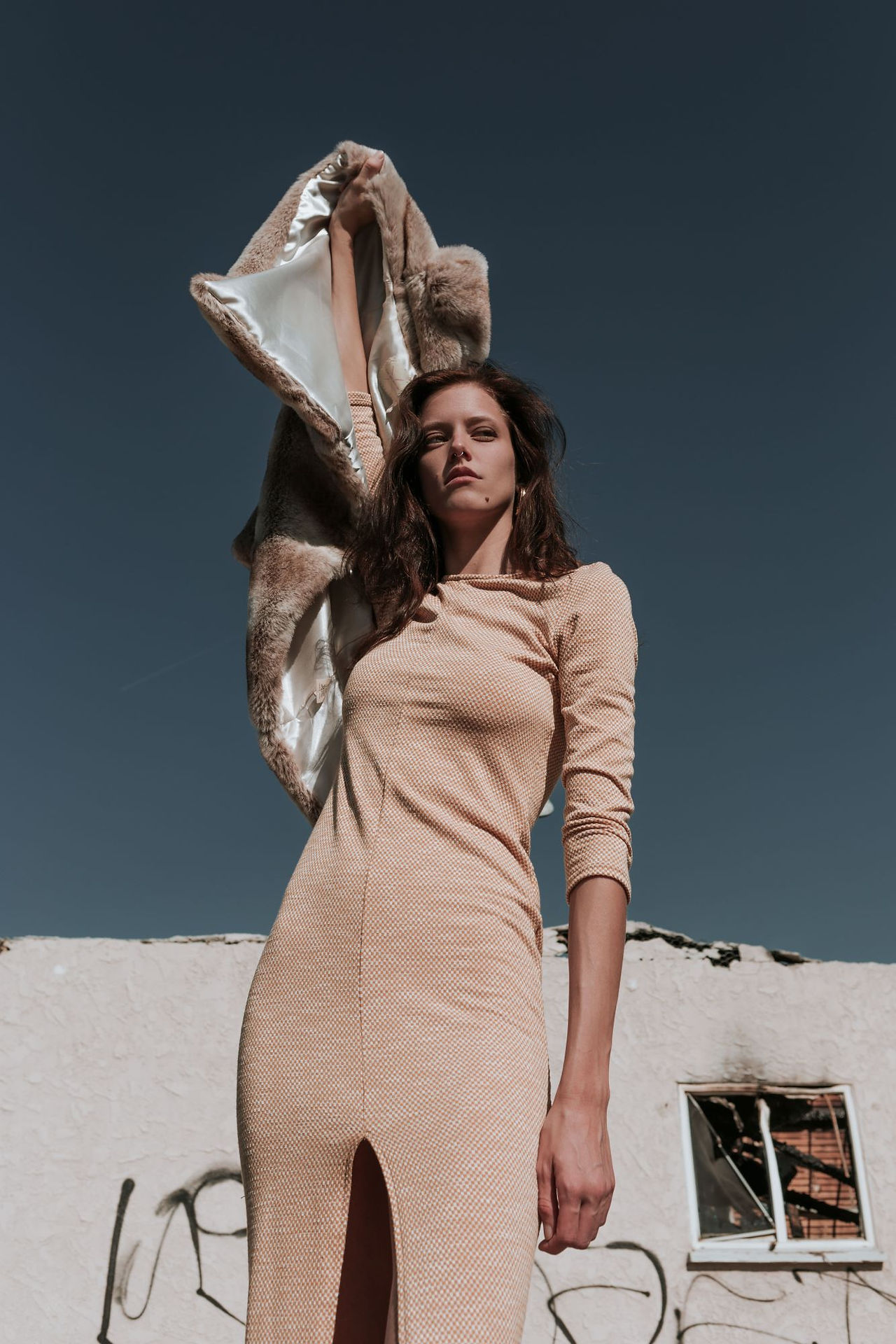 woman holding coat in air