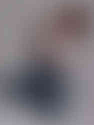 Woman in white tank and jeans kneeling