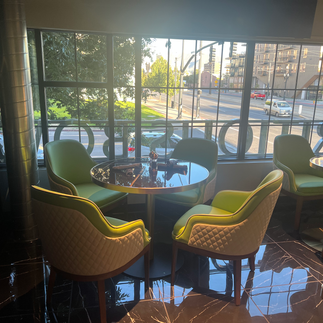 Green chairs and table in a restaurant with large windows. salt lake city dining spots