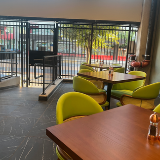 Restaurant patio with tables and chairs near a gate Salt Lake City dining spots.