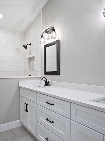 Bathroom remodeling with double vanity and modern lighting in Orlando