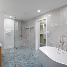 Modern bathroom with freestanding tub, walk-in shower, blue floor