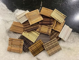 Woven wood shade color samples in natural tones including bamboo, grass, and reed materials for North Texas homes
