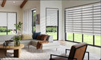 Motorized zebra shades on sliding patio doors in open living room with natural lighting