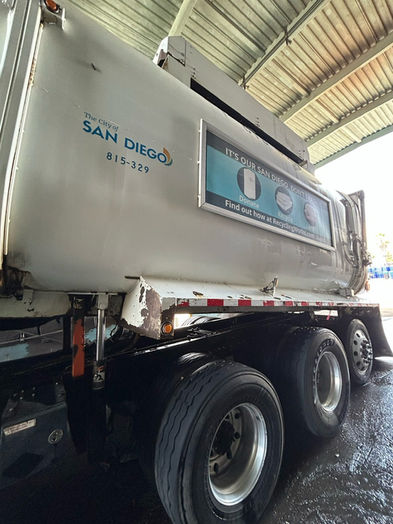 Municipal refuse truck receiving professional fleet washing services.