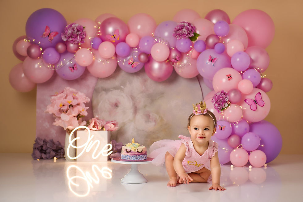 First year old girl having fun at her cake smash photoshoot in Hemel Hempstead.