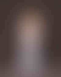 Florentina holding baby dress and shoes with soft smile