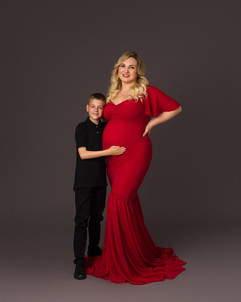 Big brother sitting beside Florentina during maternity session