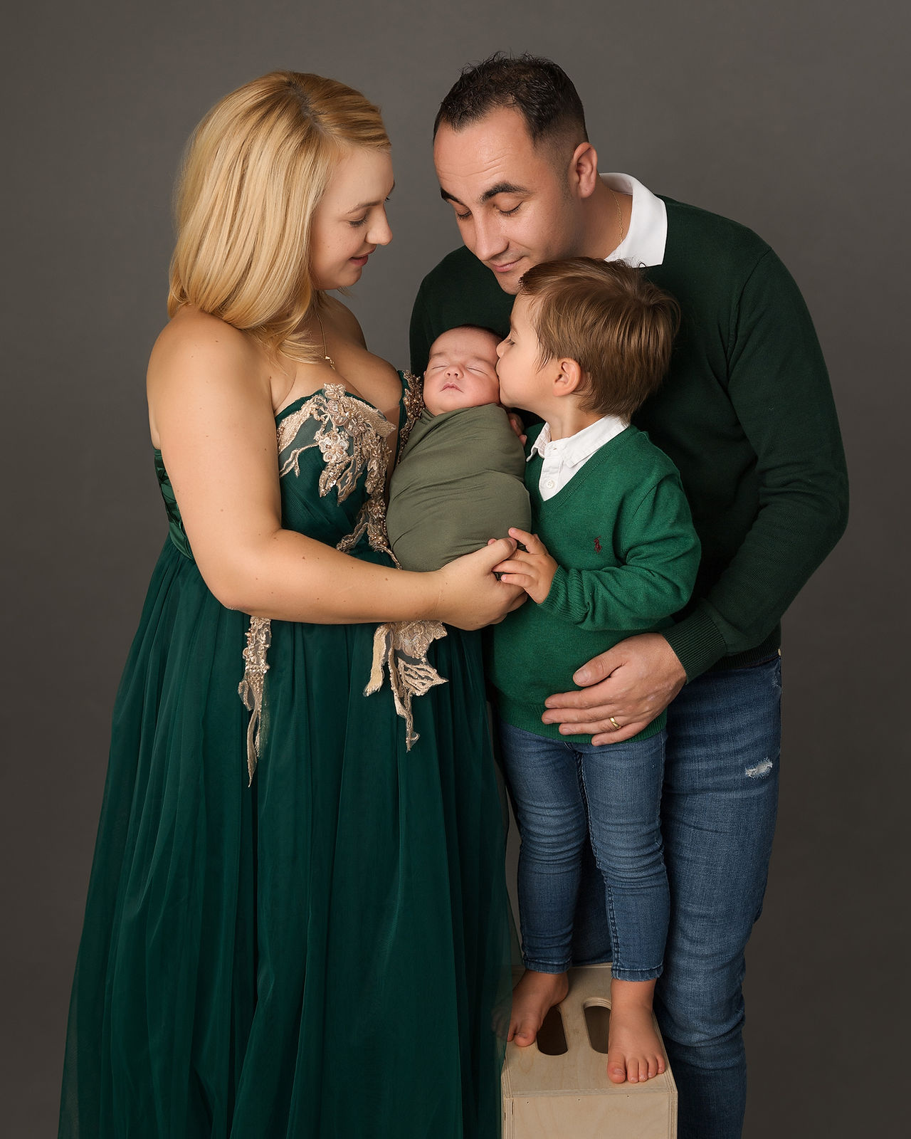 Family portrait of newborn baby girl surrounded by mum, dad and big brother