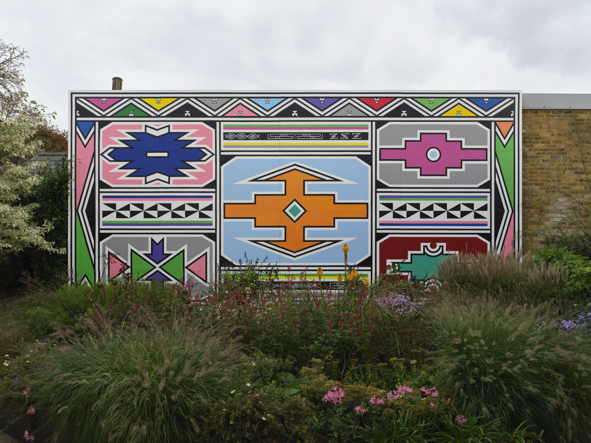 Dr Esther Mahlangu's large-scale Ndebele mural installed at Serpentine North, London, 2024