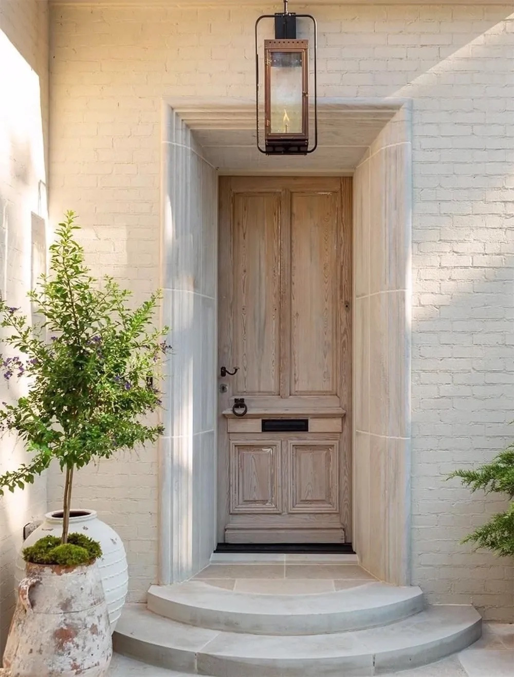 I am blown away by the beauty of this antique front door from Belgium. The pale exterior is beautiful and utterly appealing. I'd love to see the decor on the other side! | Image credit: Instagram @robinrainsinteriordesign