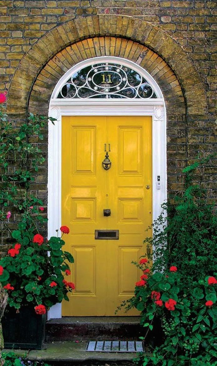 Interior design studio | Interior design blog | Interior designer | Yellow front door with glass fan. Art deco style yellow front door. Red gerbera in planters. London home facade.