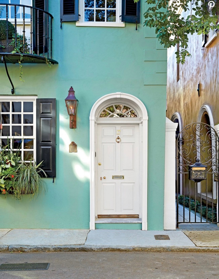 This white front door gives a completely different vibe with the house facade painted a gregarious green! The black shutters also add drama to this house frontage