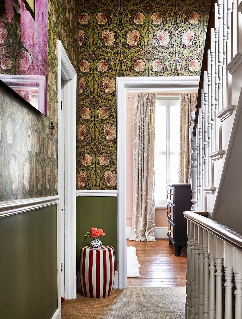 William Morris Wallpaper above dado rail. The green in the wallpaper is picked out beautifully by the green of the lower part of the wall. Image credit House & Garden. Hallway landing. Stairway decorated with William Morris wallpaper.