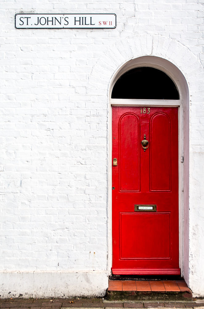 All the London vibes for this red painted door in St John's Hill, Battersea. The red against the white brick facade is impressively striking | Photo credit Christopher Riche / 500px