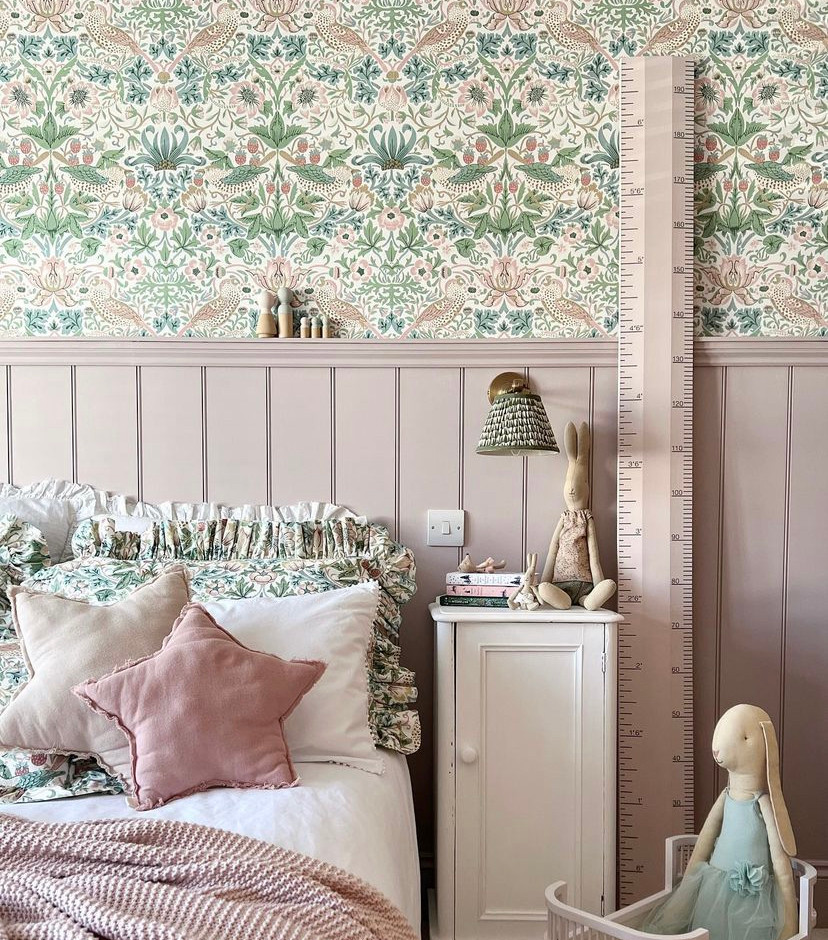 The matching William Morris print wallpaper and bedding, the pink Georgian panelling, the brass wall lights... I love everything about this stunning little girl's room design. Image credit Instagram @simplyscandikatie