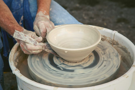 Handmade white ceramic pottery shaped by hand.