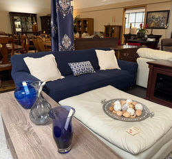 Sofa with navy blue cover and leather ottoman