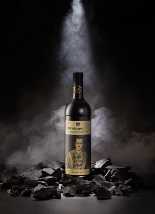 Wine bottle on smoky, rocky background.