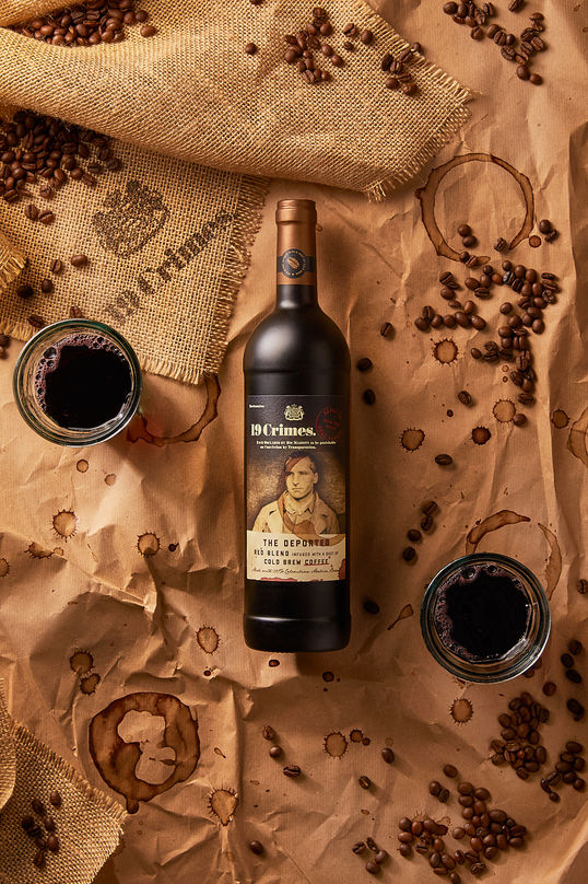 Wine bottle with coffee beans and glasses.