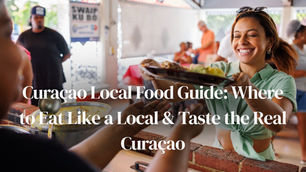 A smiling woman receives a plate of food from a vendor over a brick counter inside a busy, casual market or eatery, perfectly illustrating the Curacao Local Food Guide experience: Where to Eat Like a Local & Taste the Real Curacao