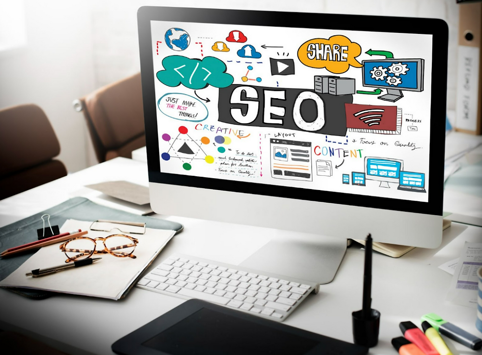 Computer screen displaying SEO concepts with colorful graphics and text. Office desk setup with keyboard, mouse, and design tools.
