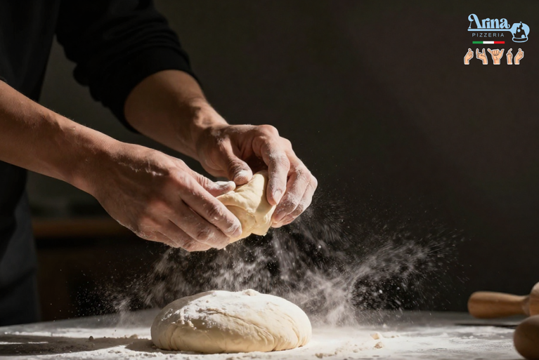 Chef preparing dough for authentic Italian pizza in Qatif using hand-stretched technique and slow fermentation process