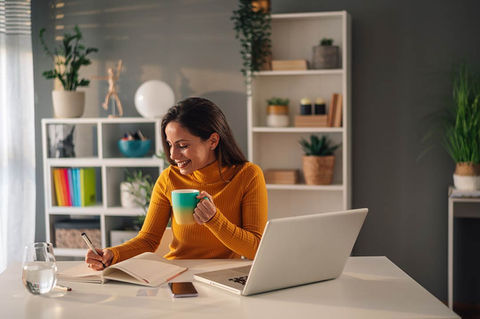 woman drinking coffee in home office