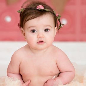 Baby sitting up and looking into the camera during an in studio photography session with k