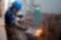 worker-wearing-protective-helmet-with-mask-gloves-while-welding-metal.jpg