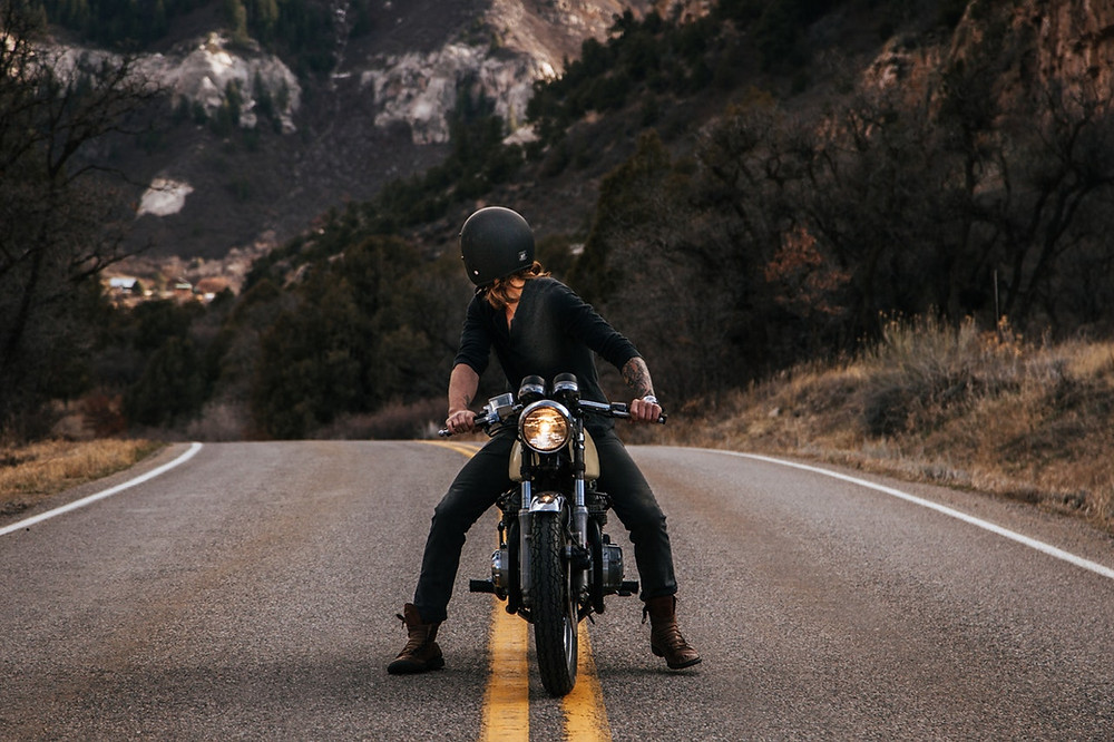a man on a bike look back on the road