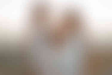 three sisters posing at sunset on the beach for a family photography session in the sutherland shire