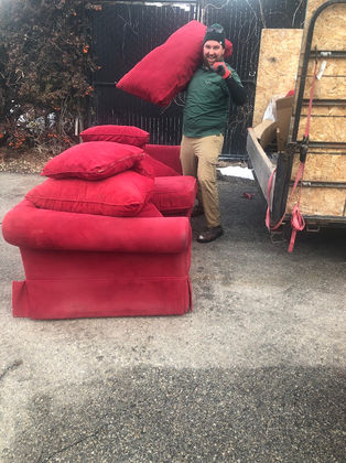 SLC Junk's employee showing excitement while loading a couch and loveseat onto SLC Junk's utility trailer.