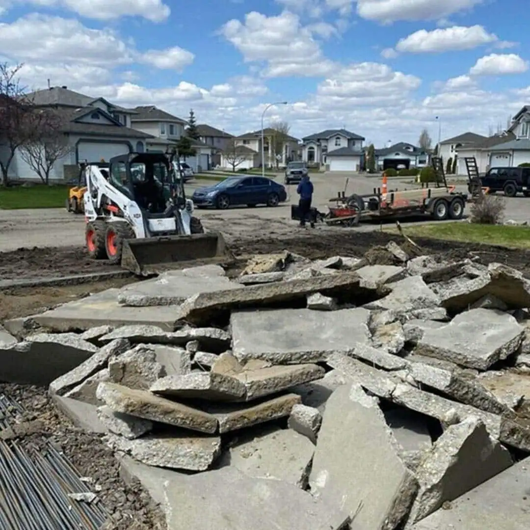 Concrete demolition and site preparation with a compact loader