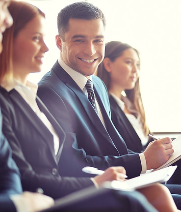 smiling-businessman-in-convention.jpg