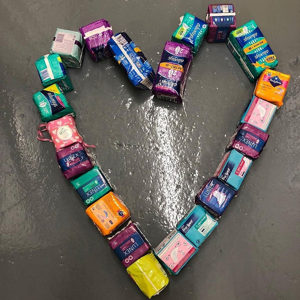 A heart shape made out of packs of period products