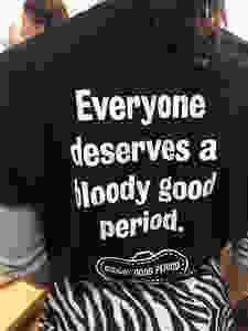 Woman wearing a T-shirt which reads 'Everyone deserves a bloody good period'