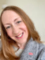 This is a close-up of Rachel smiling at the camera. She's wearing a grey jacket with a BGP red pin.