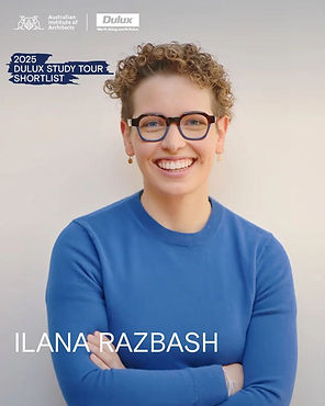 Headshot of Ilana Razbash wearing a blue top and glasses, arms crossed