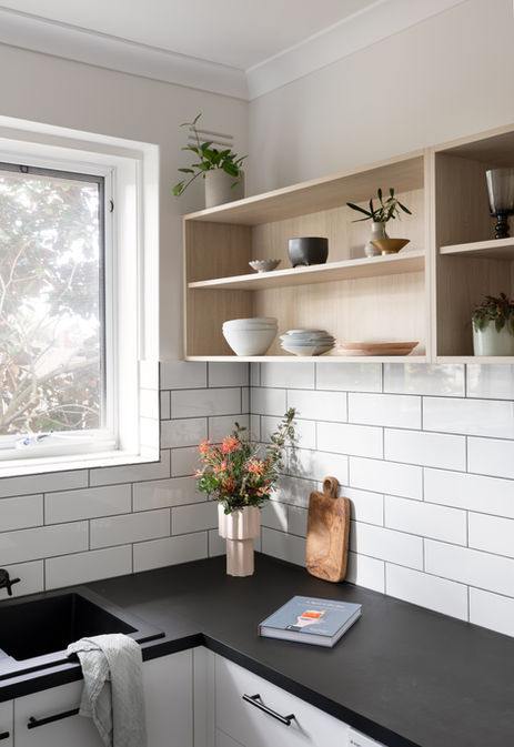 a vase of flowers sits on a counter next to a book