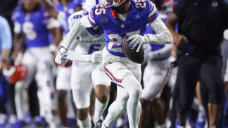 football player running with interception
