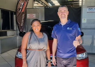 Customer and HJ Bosch & Sons technician thumbs-up beside repaired car in Pretoria West.	