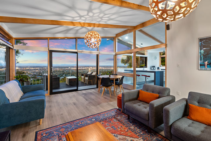 Interior real estate photography of a Cashmere home at 127 Kidson Terrace, Christchurch, showing the living area, timber ceiling details, large windows and elevated city views.