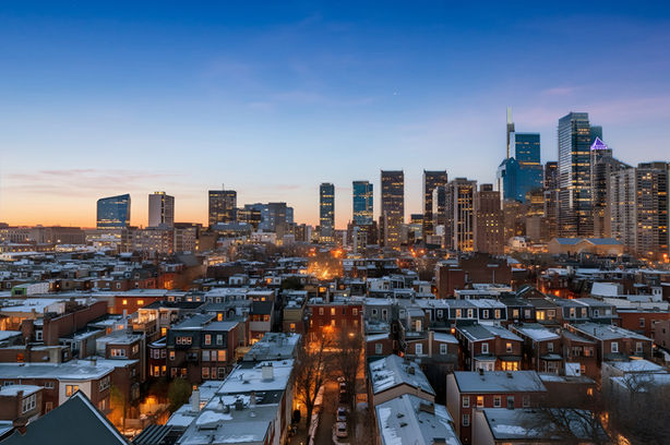 Philadelphia skyline and row houses at dusk