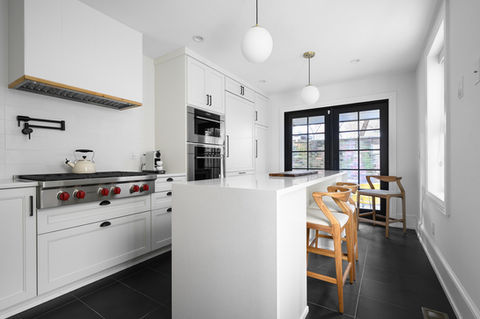 Modern white kitchen with island and black French doors