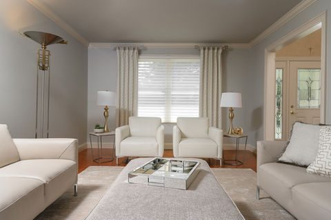 Modern living room with white armchairs and grey sofas