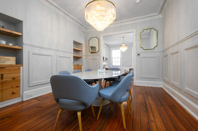 Modern dining room with wainscoting and blue chairs