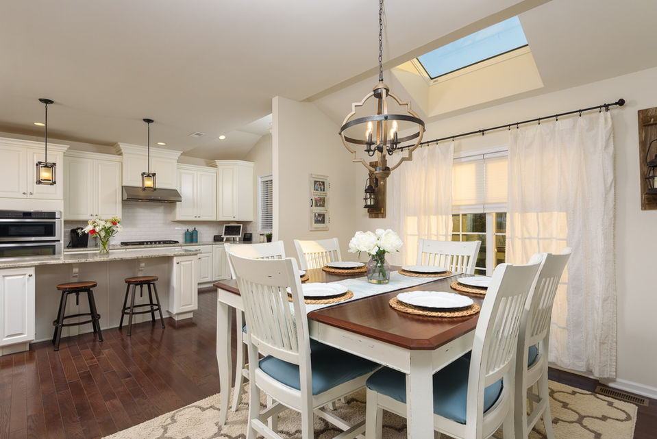 Modern dining room with white chairs and skylight