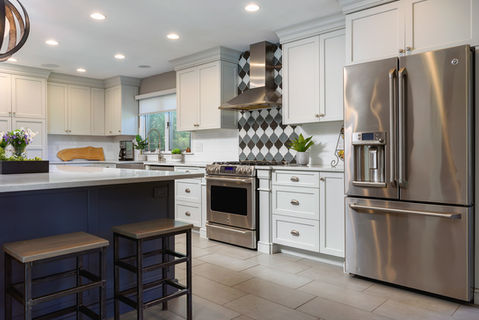 Modern kitchen with white cabinets and stainless steel appliances